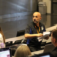 Ben hands out papers at the Compliance Jam workshop