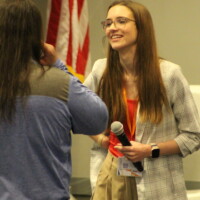 Two people speak at a conference